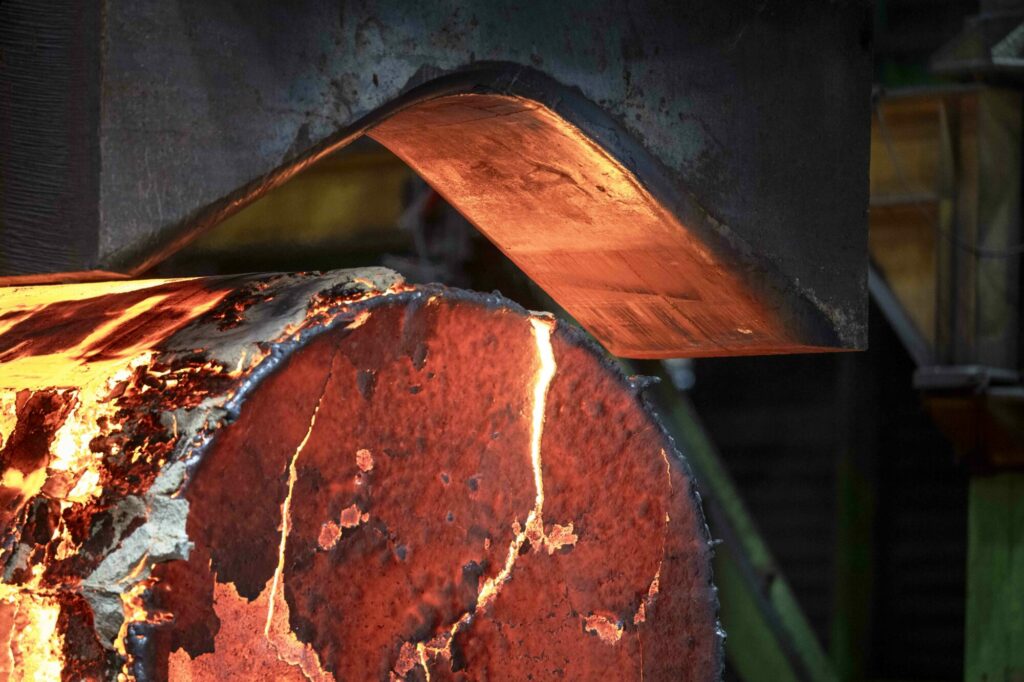  - Naissance d’un titan des mers.  Dans les ateliers d’Aubert & Duval, près de Saint-Étienne, naît l’une des pièces les plus critiques de la chaufferie nucléaire du futur porte-avions français : le coude de pompe primaire. Une pièce hors normes et innovante, conçue dans un alliage répondant à des contraintes extrêmes et nourrie du retour d’expérience des EPR civils. Sous la lumière des fours, presses et pinces semblent personnifiées. Ici se façonne une part de la souveraineté industrielle française.